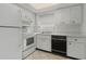 Functional kitchen featuring white appliances, tile flooring, and ample cabinet space for convenient meal preparation at 5062 White Oak Ct, Bradenton, FL 34207