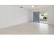 A bright living room featuring tile flooring and access to a screened patio at 5062 White Oak Ct, Bradenton, FL 34207