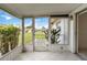 Enclosed patio area with tiled floor and view of the lawn, perfect for relaxation and outdoor enjoyment at 5062 White Oak Ct, Bradenton, FL 34207