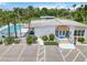 Community pool with palm trees, lounge chairs, and adjacent parking at 5062 White Oak Ct, Bradenton, FL 34207