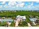 Spacious home on a sprawling lot, surrounded by lush trees, and adjacent to a scenic waterway at 512 77Th St, Holmes Beach, FL 34217