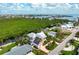 Aerial view of home with solar panels, waterfront access, and lush greenery, blending sustainability with coastal charm at 512 77Th St, Holmes Beach, FL 34217