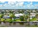 Stunning waterfront property with lush landscaping, a private dock, and a picturesque view of the canal at 512 77Th St, Holmes Beach, FL 34217