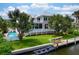 Waterfront property with a private dock, kayaks, and a sparkling pool, perfect for relaxation and recreation at 512 77Th St, Holmes Beach, FL 34217
