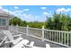 Enjoy the river view from the balcony with white Adirondack chairs and serene surroundings at 512 77Th St, Holmes Beach, FL 34217