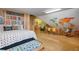Whimsical bedroom design with a world map mural and bookshelves, creating a playful and imaginative space at 512 77Th St, Holmes Beach, FL 34217