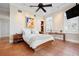 Comfortable bedroom featuring a ceiling fan, shuttered windows, and neutral paint colors at 512 77Th St, Holmes Beach, FL 34217