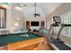 Versatile game room with a pool table, treadmill, and comfortable seating area at 512 77Th St, Holmes Beach, FL 34217