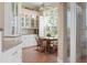 Charming breakfast nook bathed in natural light, featuring a glass cabinet and casual dining set at 512 77Th St, Holmes Beach, FL 34217