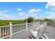 Relax on this deck with chairs and a scenic overlook view of the water and foliage at 512 77Th St, Holmes Beach, FL 34217
