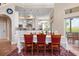 Bright dining area featuring large windows, table seating six, and access to the outdoor patio at 512 77Th St, Holmes Beach, FL 34217