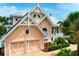 Beautiful exterior elevation featuring a coastal style and a lush landscaped yard at 512 77Th St, Holmes Beach, FL 34217