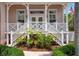 Close up of the home exterior and front door featuring manicured landscaping and white trim at 512 77Th St, Holmes Beach, FL 34217