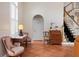 Foyer area with beautiful hardwood floors, charming chairs and table, and an adjacent staircase at 512 77Th St, Holmes Beach, FL 34217
