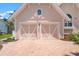 Charming garage with dual carriage doors and brick driveway at 512 77Th St, Holmes Beach, FL 34217