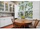 Eat-in kitchen showcasing white cabinets, tile backsplash, large windows, and a table with seating for four at 512 77Th St, Holmes Beach, FL 34217