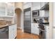 Gourmet kitchen featuring stainless steel appliances, granite countertops, and custom cabinetry with ample storage at 512 77Th St, Holmes Beach, FL 34217
