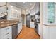 Bright, modern kitchen with stainless steel appliances, granite counters, and white cabinets at 512 77Th St, Holmes Beach, FL 34217