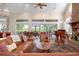 Inviting living room with fireplace, soaring ceilings, and wall of sliding glass doors to the backyard at 512 77Th St, Holmes Beach, FL 34217