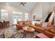 Open-concept living room with a large leather sectional sofa, area rug, and neutral walls at 512 77Th St, Holmes Beach, FL 34217