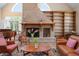 Living area with brick fireplace, vaulted ceilings, hardwood floors and a view to the window at 512 77Th St, Holmes Beach, FL 34217