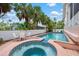 Relax by the pool and spa surrounded by lush tropical landscaping at 512 77Th St, Holmes Beach, FL 34217