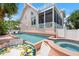Inviting backyard featuring a sparkling pool, spa, and screened-in porch, ideal for relaxation and outdoor entertaining at 512 77Th St, Holmes Beach, FL 34217