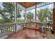Relaxing porch with a wooden swing, offering views of the lush greenery and providing a tranquil retreat at 512 77Th St, Holmes Beach, FL 34217