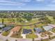 Aerial view of the property showcasing its location near a golf course and water feature at 5125 Palm Aire Dr, Sarasota, FL 34243