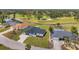 Aerial shot showcasing a home with a well manicured lawn near a golf course and waterway at 5125 Palm Aire Dr, Sarasota, FL 34243