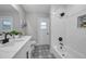 Modern bathroom with white subway tile in shower and black and white patterned tile floors at 5125 Palm Aire Dr, Sarasota, FL 34243