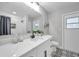 A bathroom with a shower/tub, patterned tile floor and a bright white vanity at 5125 Palm Aire Dr, Sarasota, FL 34243
