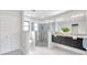 Modern bathroom featuring a walk-in shower with decorative tile and a double vanity at 5125 Palm Aire Dr, Sarasota, FL 34243