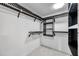 A walk-in closet with black metal fixtures including shelves and clothing rods at 5125 Palm Aire Dr, Sarasota, FL 34243