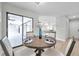 Cozy dining area features a wood table setting with seating for four and sliding glass doors to lanai at 5125 Palm Aire Dr, Sarasota, FL 34243