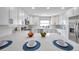 Updated kitchen features white cabinets, quartz countertops, stainless steel appliances, and modern finishes at 5125 Palm Aire Dr, Sarasota, FL 34243