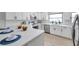 Modern kitchen with white cabinets, quartz countertops, stainless steel appliances, and stylish backsplash at 5125 Palm Aire Dr, Sarasota, FL 34243