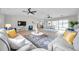 Expansive living area with natural light, wood floors, ceiling fans, and comfortable seating at 5125 Palm Aire Dr, Sarasota, FL 34243