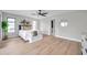 Bright main bedroom with light wood floors, ceiling fan, and windows offering plenty of natural light at 5125 Palm Aire Dr, Sarasota, FL 34243