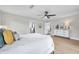 Bright main bedroom boasts ceiling fan, wood flooring, a dresser and neutral décor at 5125 Palm Aire Dr, Sarasota, FL 34243