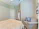 Neutral bedroom with a cozy chair, hardwood floors and a large window for ample sunlight at 5205 88Th E St, Bradenton, FL 34211