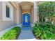 Intricate glasswork decorates the inviting blue front door, enhancing curb appeal with stylish details at 5205 88Th E St, Bradenton, FL 34211