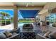 Covered patio with outdoor seating, awning, and a view of the pool and landscaped yard at 5205 88Th E St, Bradenton, FL 34211