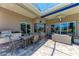 Covered patio with outdoor seating, grill, and views of the pool and landscaped yard at 5205 88Th E St, Bradenton, FL 34211