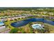 Wide aerial shot featuring the residential community, lake, and a community pool with clubhouse at 5358 Shell Mound Cir, Punta Gorda, FL 33982