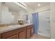 Well-lit bathroom featuring dual sinks, granite countertops, and a shower with curtain at 5358 Shell Mound Cir, Punta Gorda, FL 33982