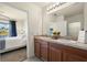 Bathroom featuring double sinks and natural light plus access to the ensuite bedroom at 5358 Shell Mound Cir, Punta Gorda, FL 33982