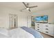 Bedroom showing an ensuite bath and seating area, plus a ceiling fan at 5358 Shell Mound Cir, Punta Gorda, FL 33982