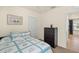 Comfortable bedroom with a twin bed, beach decor and a dresser for ample storage at 5358 Shell Mound Cir, Punta Gorda, FL 33982