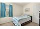 Charming bedroom with a twin bed, beach-themed decor, and plenty of natural light from the large window at 5358 Shell Mound Cir, Punta Gorda, FL 33982